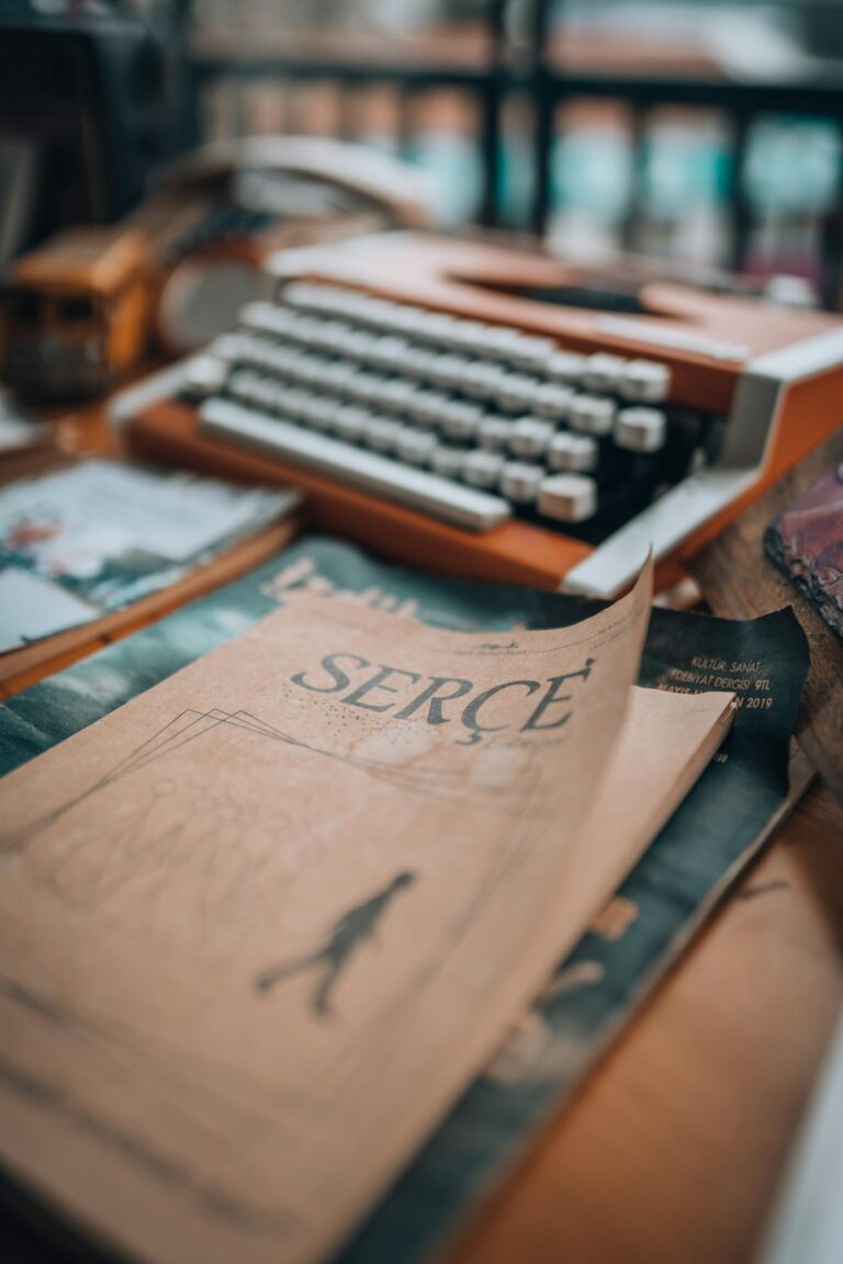 A vintage typewriter and old book create a nostalgic, literary atmosphere.